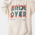 A unisex beige hoodie with a vibrant white ink direct spray design, crafted by a streetwear hoodie manufacturer.
