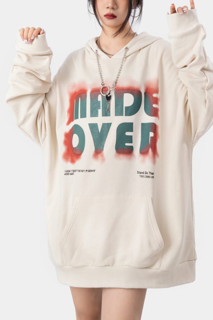 A unisex beige hoodie with a vibrant white ink direct spray design, crafted by a streetwear hoodie manufacturer.