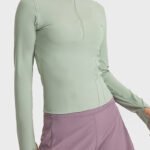 Front view of stylish ladies gym wear zip-up sports top by Yuanyi Apparel